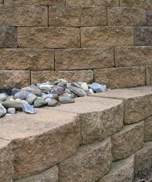 A pile of rocks sitting on top of a stone wall